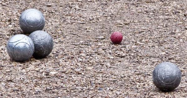 Play a petanque ball game in a parisian park